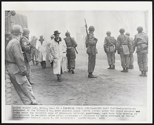 Sentries Guard Strike-Bound Meat Plant--Supervisory personnel of the Wilson & Co. meat packing plant (white coats) enter the plant grounds today under the watchful eyes of Minnesota national guardsmen, sent here this morning by the governor to maintain order after outbreaks of violence by union strikers of United Packinghouse Workers Local 6.