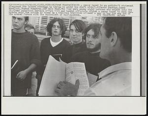 Wilfred Mische (R) with a penny taped to an antidraft statement discusses the latest strategy in trying to avoid the draft with (L-R) David Hopkins, James Mondloch, Thomas Humphrey, and Dale Nied. The four were among eight persons who walked into the St. Cloud Selective Service office 9/23 and handed officials bibles a penny taped to each one. Mische said the action is based on a biblical tradition allowed a man to buy his way out of the armyed forces with the equivalent of half-a-penny.