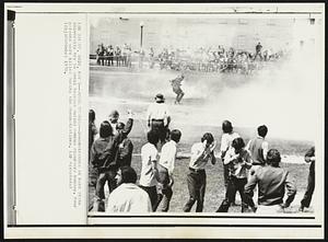 Dodge Teargas--Demonstrators at Kent State University try to avoid teargas during campus disorders Monday. Four persons were killed during the demonstrations.