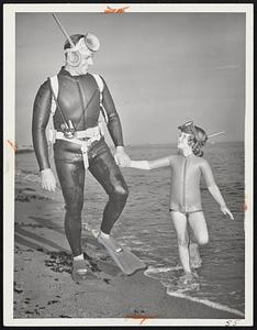 Connecticut State Trooper Robert Dee emerges from depths near Madison, Conn., with his daughter, Debbie, 5, in tow. Skin diving pair explore silent world beneath waves together.