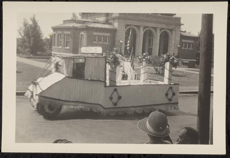 Parade float passing Lawrence Library