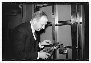 A man demonstrating how to break into a safe