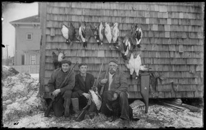 3 men w/ shotguns and ducks hanging