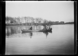 2 men in canoe (on pond?)