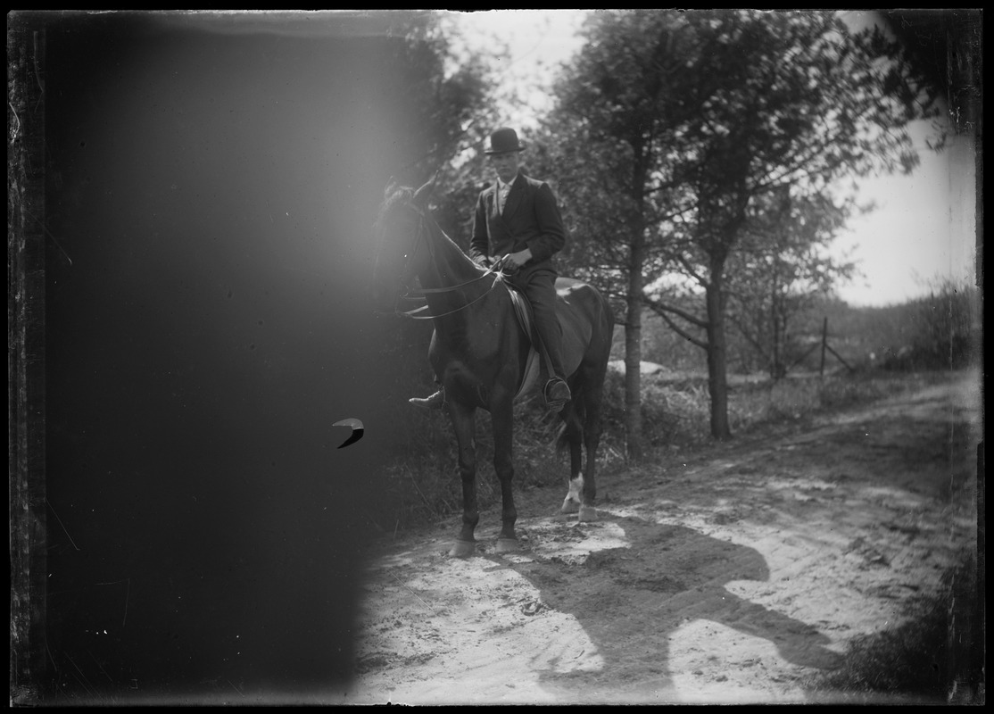 Man on horseback wearing derby