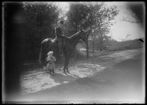 Man on horseback w/ small girl