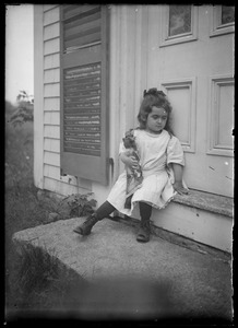 Young girl c. 6 yrs w/ doll on unknown front step