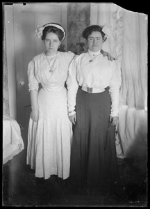2 young women. Tight waisted, long ankle length skirts