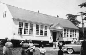 The old school was rescued in 1958 by mover Bob Hayden and relocated a half mile west on Route 28. It became an antique shop and later a funeral home