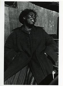 Portrait of woman smiling with hands in coat pockets