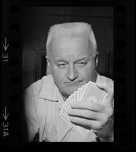 Player checks his cards at a bridge players convention, Hynes Auditorium