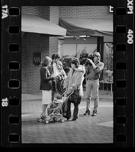 Market researcher interviews customers at shopping mall in Brighton