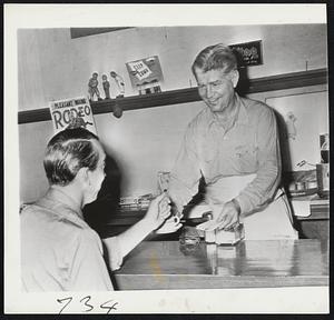 Art (the Great) Shires serves campaign cards with coffee to a customer in his restaurant in Dallas, Texas, “Whattaman,” a former major league first baseman, is running for state representative. His 13 years in the big league included turbulent turns with the Chicago White Sox, Washington Senators, Boston Braves and the St. Louis Cardinals.