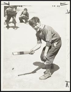 “Peggy,” on of the oldest boys’ games known, was revived in a championship playoff on the Charles street mall on the Common today. Here is Vincent McLaughling, who represented the Emmons playground, Charlestown, in the competition. The game was revived under the sponsorship of the Boston park department. A gold medal was presented by Park Commissioner Long.