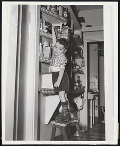 Jam Jar Reach-Like any little boy, three-year-old polio victim Paul McGonigle of 64 Elm street, Charlestown, gets the overwhelming urge to raid the pantry shelf, despite his leg braces. Success of the March of Dimes campaign can speed the day when Paul can climb unhandicapped.