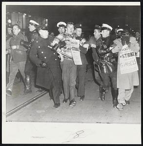 Break Up New York Picket Line- Police hustle away pickets from a New York department store. Seven AFL unions struck five department stores and have maintained a picket line since Nov. 27. Police said the pickets were a disturbance.