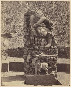 Sculpture of headless figure, incorporating smaller figures and chains of heads, India