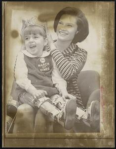 Chance to place a crown on the head of 5-year-old Donna Hill who seems to be enjoying the honor here 12/1. Donna, of Hillsboro, Texas, is the 1967 March of Dimes National Poster Child and symbolizes the organization's fight against birth defects.