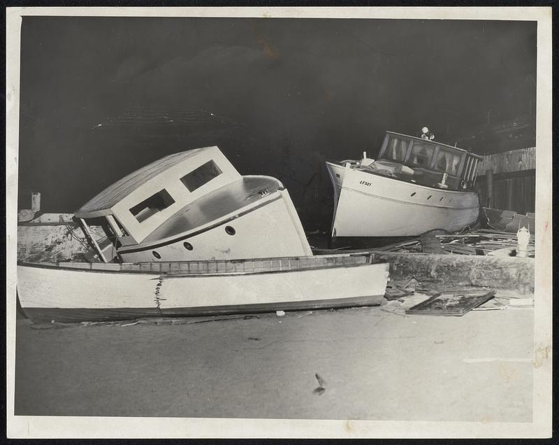 Smashed Boats lie alongside the L St. Baathhouse in South Boston after being thrown up on the beach by New England's third major hurricane in 16 years.