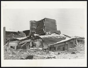 Shattered by the new earthquake of Oct. 31, the Helena, Mont., high school is shown here as it appeared after the earth tremors had ceased.