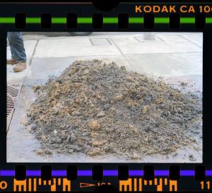 Pile of dirt on sidewalk
