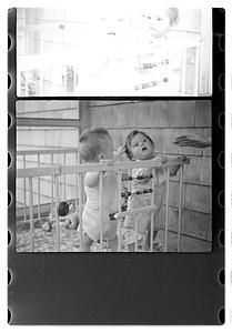 Two children in a playpen