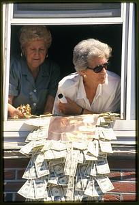 Boston - North End - 2002 Two women in a window with their donation to place on a statue of St. Anthony - St. Anthony Feast