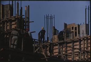 Workers on wooden framework under construction