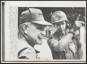 Explains Tactics-- Gen. Creighton W. Abrams, commander of U.S. Forces in Vietnam, chews on his cigar as Col. George Patton, son of the famed World War II general, explains tactics used to secure a village 25 miles north of Saigon. Patton's 11th Armored Regiment sealed off the village of Chan Luu while Vietnamese troops flushed out Viet Cong guerrillas.