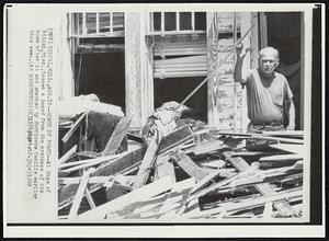 Board by Board--Al Sage of Biloxi, Miss., tosses a board from the wreckage of his home after it was smashed by Hurricane Camille earlier this week.