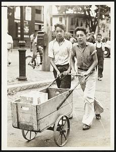 Erstwhile icemen. James Martin and Francis Thomas, both of Somerville, found it necessary to make their own ice deliveries yesterday as a result of the strike called by the truck drivers of the Metropoltan Ice Company.