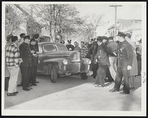 Heavy Police Guard enables car of non-strikers to pass through some 60 pickets at the Quincy terminal of the Eastern Massachusetts Street Railway. Another car was almost overturned while police were not the alert as they were here.