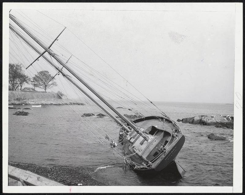 Ship Awry - Once a queen of the Marblehead fleet, the Mohawk (above) was tossed up on the sand near the Adams House by hurricane winds. Old Fort Sewell is in the background. At left the same craft is shown in an aerial view by Arber-French and Co.