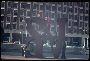 Children standing on Love statue, Boston City Hall plaza