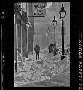 Person walking down snowy street