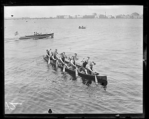 9 people in a canoe, rowing