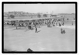 A crowd of people gathered by buses