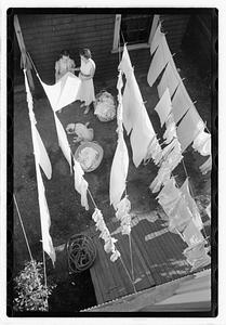 Women hanging laundry on clotheslines