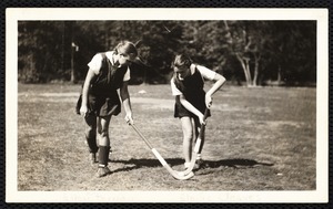 Ellen K. Pernaa, on left - and Elaine Cleaves, student head of hockey at Fitchburg S.T.C., are demonstrating the technique of stick handling in field hockey.