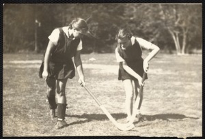 Ellen K. Pernaa, on left - and Elaine Cleaves, student head of hockey at Fitchburg S.T.C., are demonstrating the technique of stick handling in field hockey.