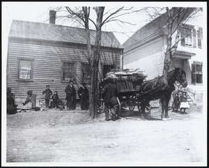 Horse and loaded wagon at front of house