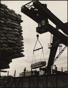 Loading railroad - ties onto flat cars at Wiggins terminals in Charlestown