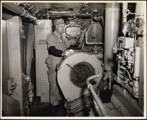 Fireman A. B. Briggs shown in engine room of diesel freight engine #4207