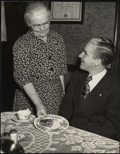 John E. Kerrigan's mother serving him a piece of homemade pie