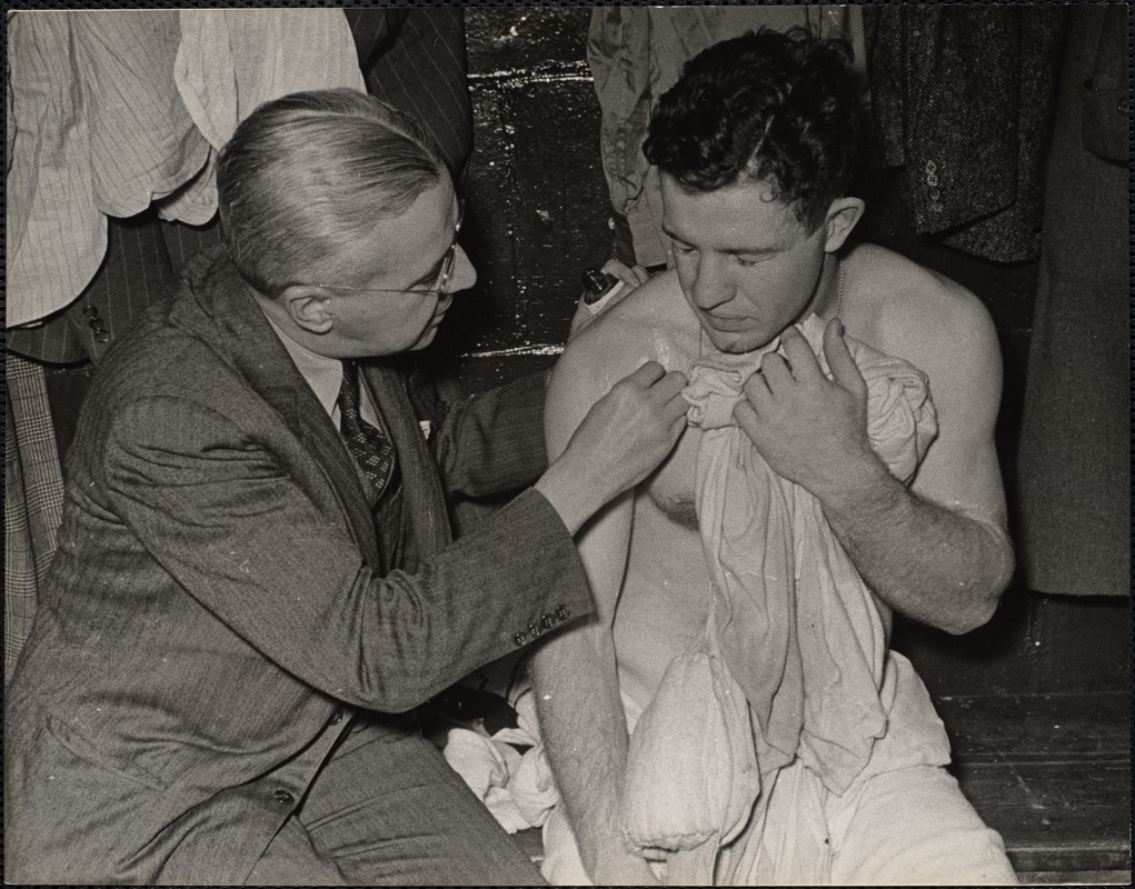 Dr Crotts examines Bobbie Bauer's injured shoulder