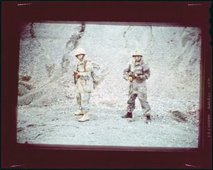 Cemel- 2 men in camouflage fatigues, front view, with rifles