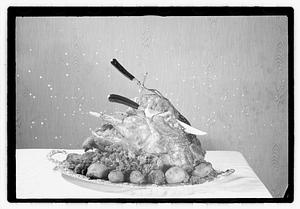 Carving knife and fork in cooked turkey