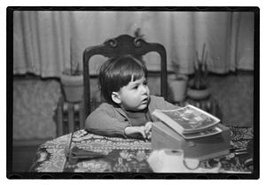 Toddler sitting a table