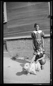 Yvonne Miller stands watching another girl and a dog