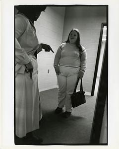 Teacher addressing a student in a hallway